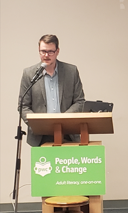 photo of Andrew Forbes the keynote speaker speaking at the podium giving his address.