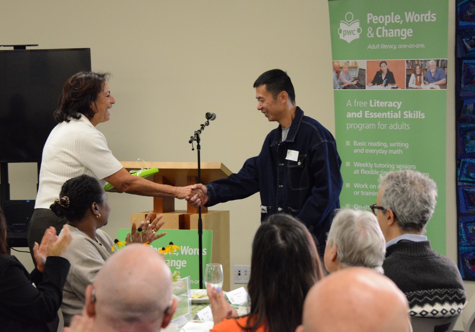 learner speaker Feng shaking hands with Marcia who is thanking him for speaking