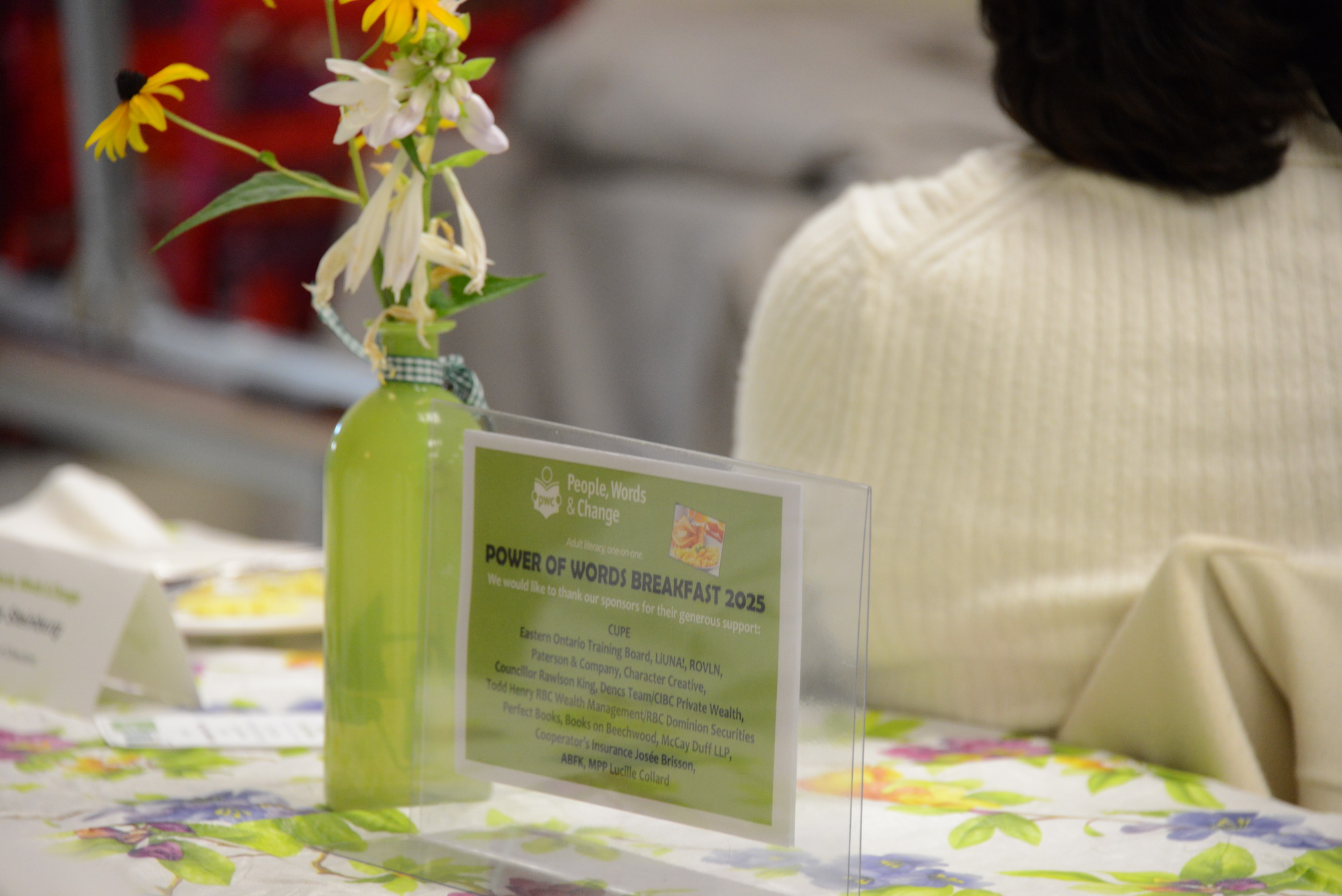 photo of the sponsors and flowers at table